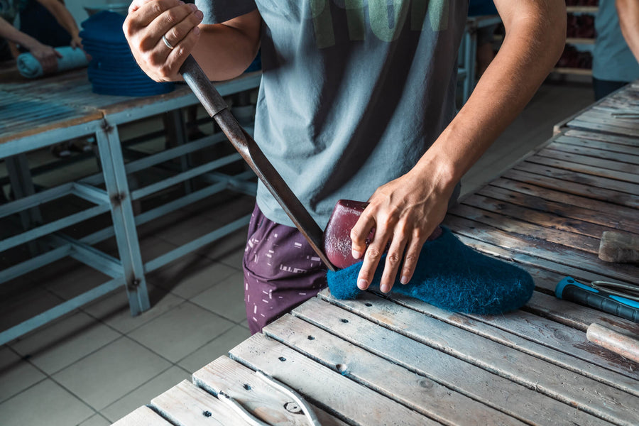 Kyrgyz artisan shaping a wool felt slipper by hand in the Bishkek workshop